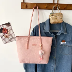 Pink embossed tote bag for women, large capacity shoulder bag with cute fluffy charm, daily commuter.