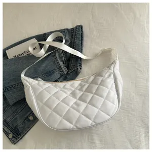 White quilted nylon crescent shoulder bag detail view, casual crossbody handbag closeup.
