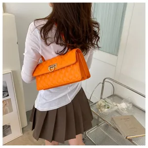 Stylish orange quilted underarm bag with metal lock, trendy women shoulder bag for daily wear.