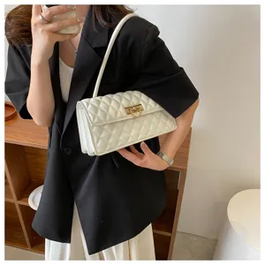 Elegant white diamond quilted shoulder bag with chic gold lock clasp, stylish women's baguette.