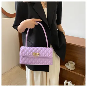 Detail shot of the elegant light purple quilted underarm shoulder bag with gold metal lock.
