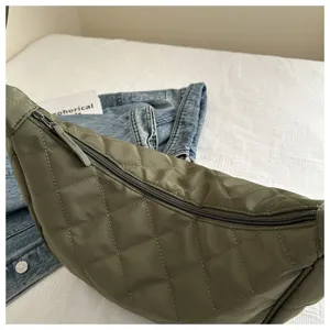 Detailed view of the quilted nylon crossbody bag, stylish green dumpling shoulder bag.