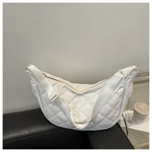 Detailed view of the white quilted nylon crescent shoulder bag showcasing spacious interior.