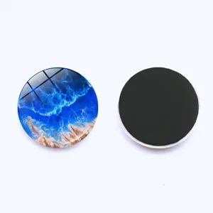 Detailed view of ocean wave glass fridge magnet showing vibrant blue pattern and magnetic back.