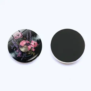 Close-up detail of vintage vinyl record floral fridge magnet with glass dome and magnet back.