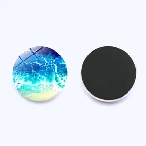 Crystal glass round fridge magnet detail, ocean wave pattern close up view, soft magnetic backing.