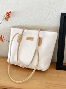 White contrast tote bag with top handle and embossed pattern, stylish daily commuter handbag.