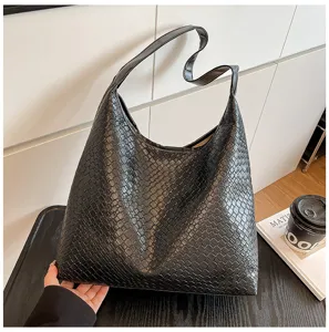 Detailed view of a minimalist black textured hobo shoulder bag with a slouchy design for women.