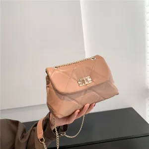 Elegant beige quilted shoulder bag with chain strap and chic metal lock for women stylish.