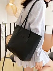 Stylish black PU leather tote bag for women, large capacity embossed shoulder bag for daily commute.