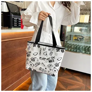 Casual canvas tote bag with trendy black and white graffiti print, large capacity commuter shoulder bag.