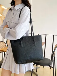 Black leather tote bag for women, large capacity shoulder bag with embossed design and chic style.