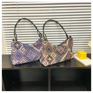 Woven pattern shoulder bag detail view showcasing the textured fabric and black strap design.