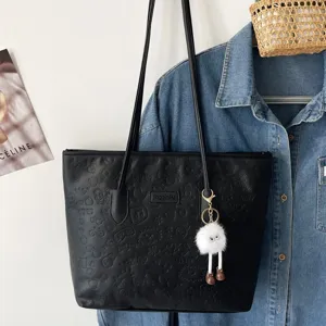 Black tote bag for women large capacity daily commuter PU leather shoulder bag with fluffy pendant.