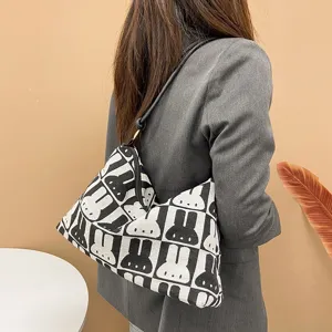 Trendy black and white canvas shoulder bag with cute rabbit pattern for women students.