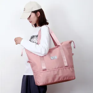 Detail shot of the large pink nylon travel duffel bag worn by a model showcasing capacity.