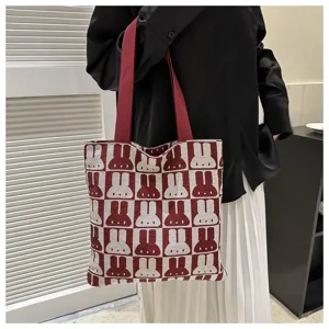 Knit tote bag detail view, featuring red and white checkered pattern with cute rabbit design.