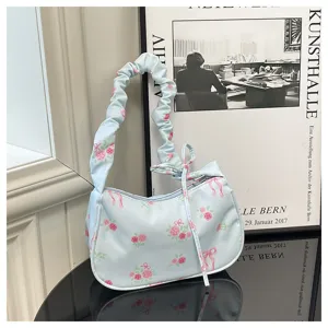 Sweet floral shoulder bag detail, light blue fabric with pink roses and cute bow accents.
