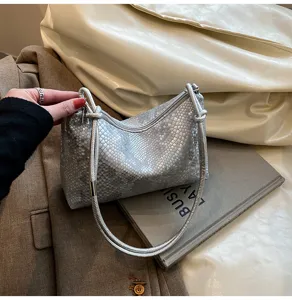 Silver snakeskin shoulder bag, fashionable underarm handbag for women commute and daily wear.