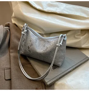 Silver snake-print shoulder bag detail, elegant design with zipper and strap for women.