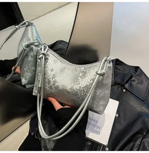 Silver metallic snakeskin texture shoulder underarm bag with knotted straps for women.