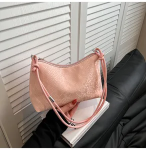 Pink snake pattern shoulder bag detail, elegant texture and metal hardware strap accent.