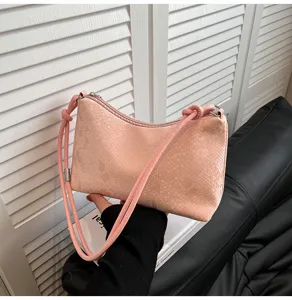 Pink textured leather shoulder underarm bag detail view, fashionable and versatile design.