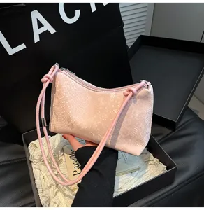 Pink snake pattern underarm bag detail, featuring sleek zipper closure and stylish knotted shoulder strap.