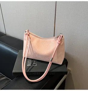 Detail view of pink snake pattern PU leather shoulder bag, trendy underarm purse hardware.