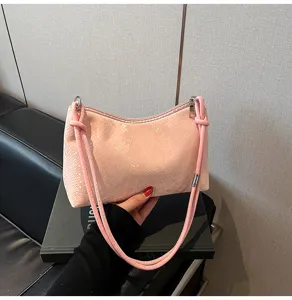 Pink faux leather shoulder underarm bag detail view, stylish commuter handbag for women.