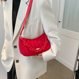 Red quilted shoulder bag with chunky chain strap, elegant women handbag for winter fashion daily use.