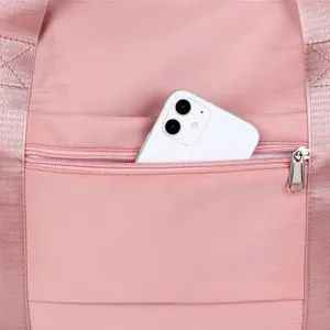 Pink nylon travel gym bag zipper pocket detail closeup, practical daily accessory
