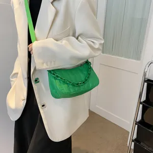 Chic green quilted shoulder bag with chunky chain detail, stylish cross-body bag for women