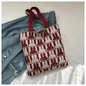 Detailed view of the red and white knitted rabbit pattern tote bag, casual shoulder bag style.