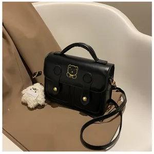 Vintage mini PU leather satchel crossbody bag with cute bear embroidery and fluffy charm detail.