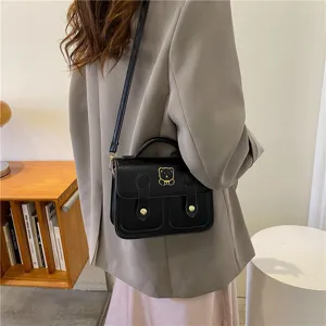 Black PU leather vintage mini satchel bag with cute bear charm for women daily commuting style.