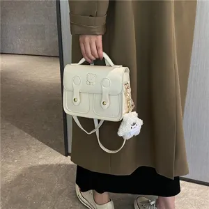 Vintage PU leather satchel bag with cute bear pendant for women daily commuting.