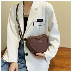 Detail view of brown heart-shaped crossbody bag, stylish PU leather sweet fashion purse.