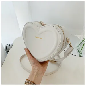 White heart-shaped crossbody bag, cute sweet fashion shoulder bag for women daily casual wear.