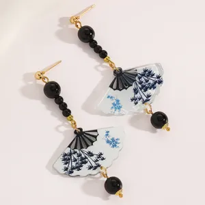 Detailed view of new Chinese style fan-shaped earrings with blue floral relief pattern