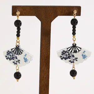 Close-up of Chinese style fan-shaped drop earrings with black beads