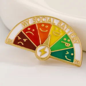 Macro view of colorful social battery enamel pin with sliding pointer