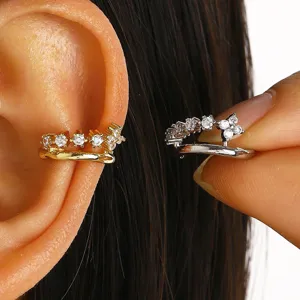 Close-up of sparkling cz cuff earrings in gold and silver plating