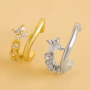 Detailed view of two elegant flower cubic zirconia ear cuffs in gold and silver plating