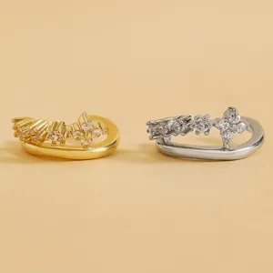 Close-up detail of multi-layered vintage zircon ear cuffs in gold and silver finish