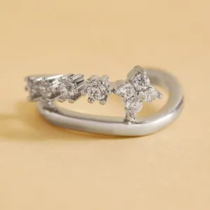 Detailed macro shot of a silver zircon ear cuff with sparkling floral crystal clusters.