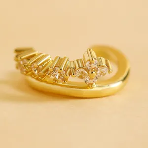 Macro view of gold vintage ear cuff with sparkling zircon stones in a floral setting