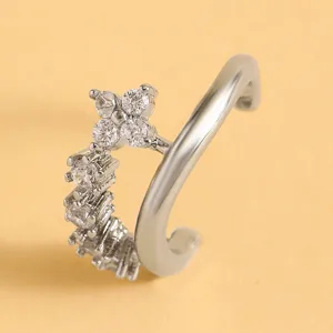 Macro detail of a silver-toned ear cuff featuring intricate sparkling zircon stones