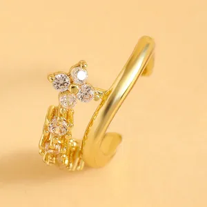 Close-up of a gold-plated multi-layer ear cuff featuring hollow design and sparkling cubic zirconia