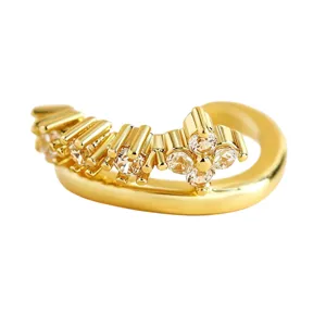Close-up of gold-plated ear cuff featuring sparkling cubic zirconia stones in floral setting